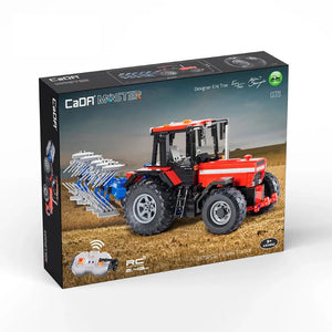 Boxed model of a red and black tractor with plow attachments on a white background