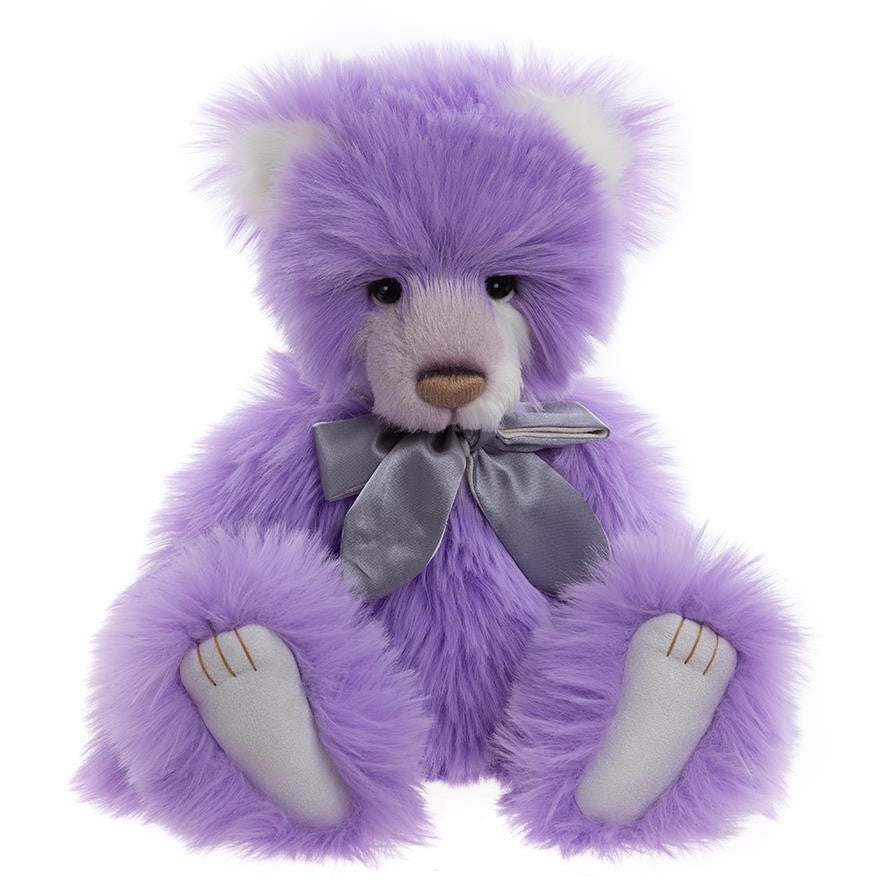 Purple teddy bear with a gray bow on a white background
