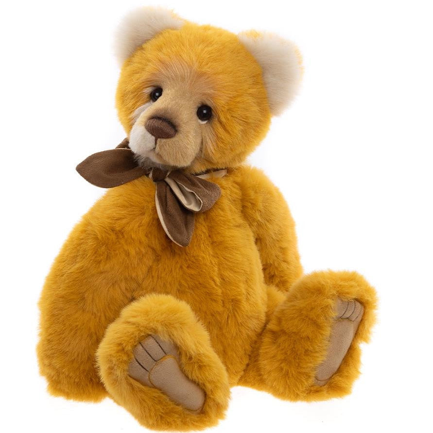Yellow teddy bear with a brown bow tie on a white background