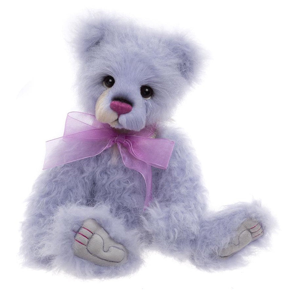 Blue teddy bear with a pink bow on a white background