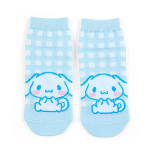 Pair of light blue socks with cartoon character on a white background