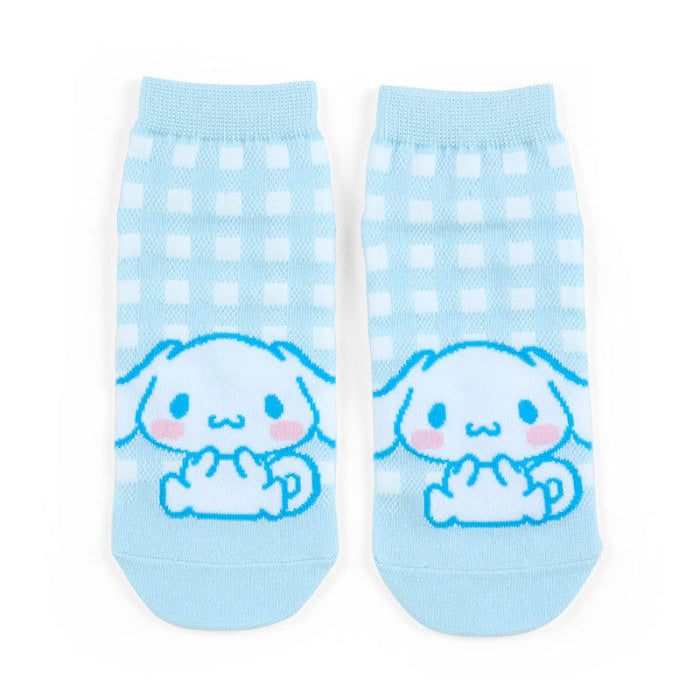 Pair of light blue socks with cartoon character on a white background