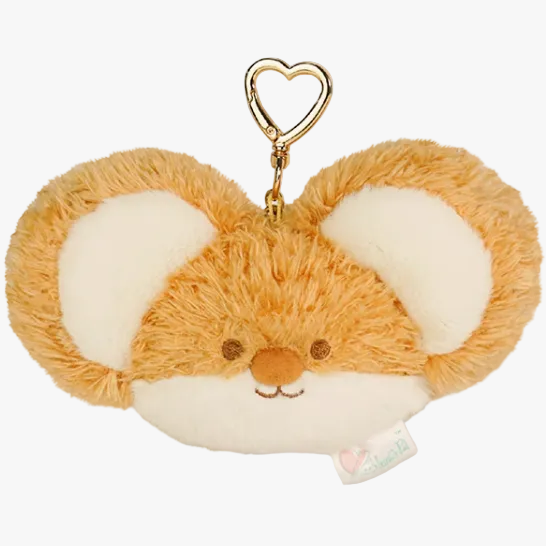 Plush fox keychain with a heart-shaped clip on a beige background