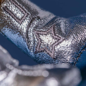 Close-up of a textured metallic surface with a star design.