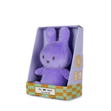 Purple plush toy in a branded box on a white background