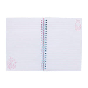 Notebook with pink floral design on white background