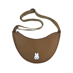 Brown crossbody bag with a small white rabbit emblem on a white background