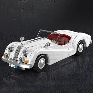 White convertible car model made of interlocking bricks on a dark textured background