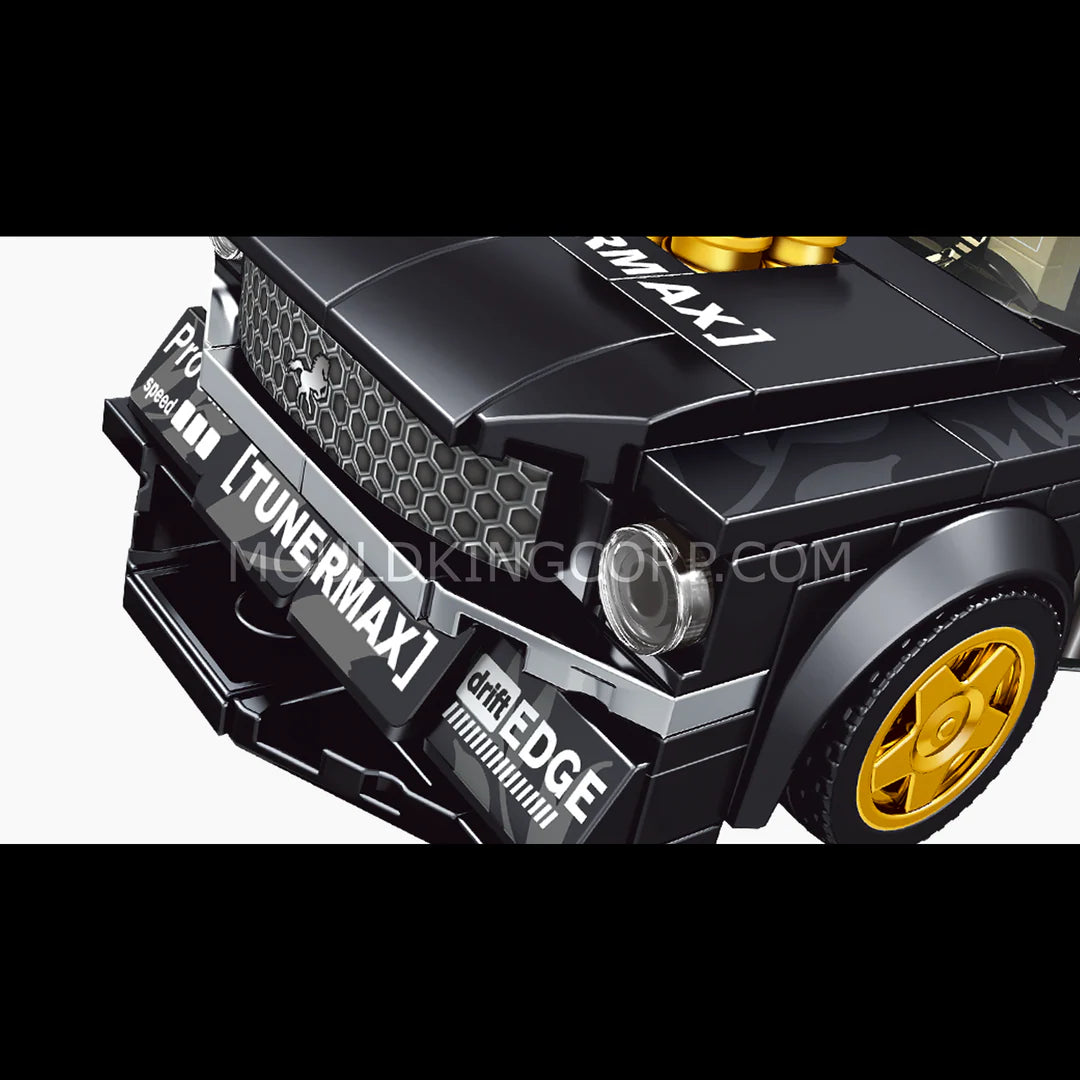 Close-up of a black toy car with gold accents and 'Tunermax' branding on a white background.