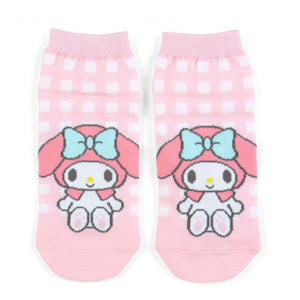 Pair of pink socks with cartoon character and bow design on a white background