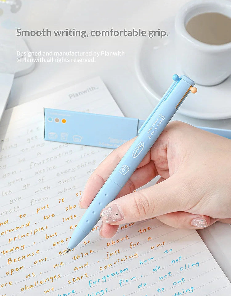 Hand holding a light blue pen over a notebook with a cup of coffee in the background.