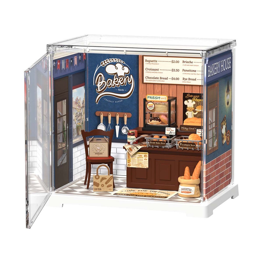 Model of a bakery shop with a 'Baker' sign and various bakery items.