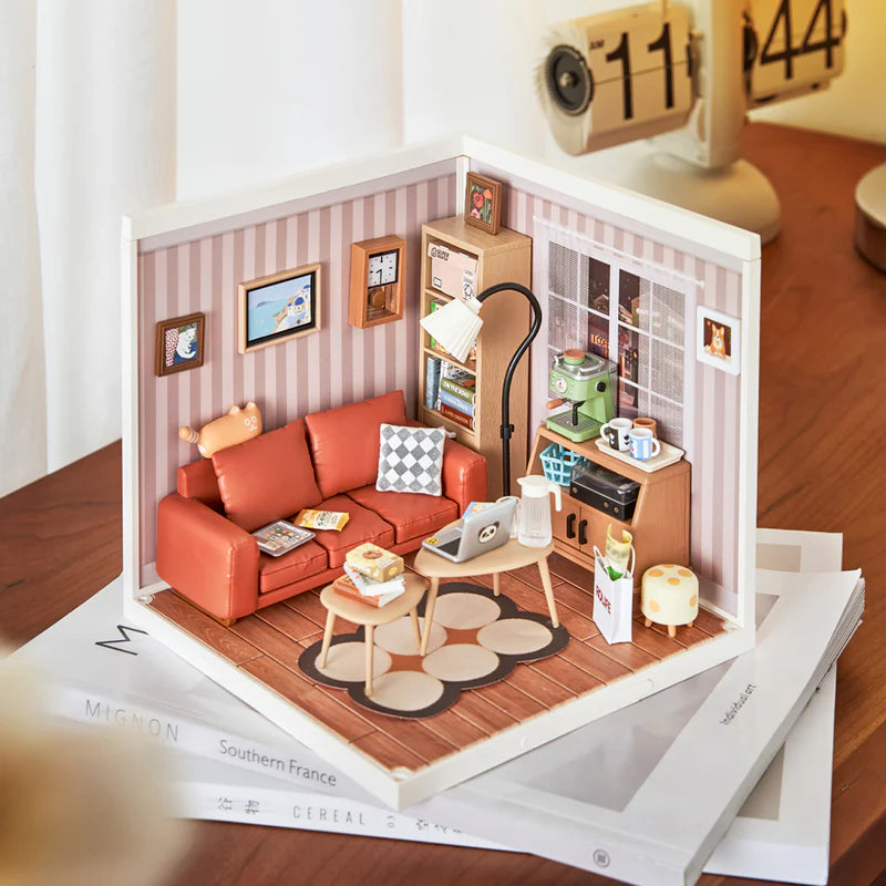 Miniature model of a living room with furniture and decor on a book