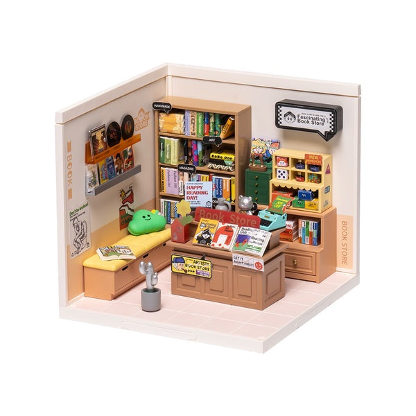Miniature model of a book store with shelves, books, and furniture on a white background