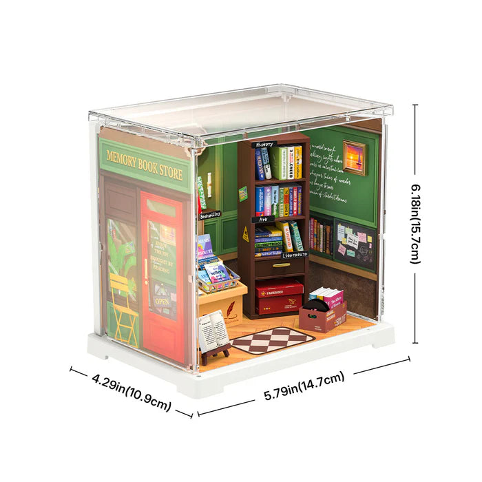 Miniature bookshelf model with books and furniture, shown with dimensions on a white background.