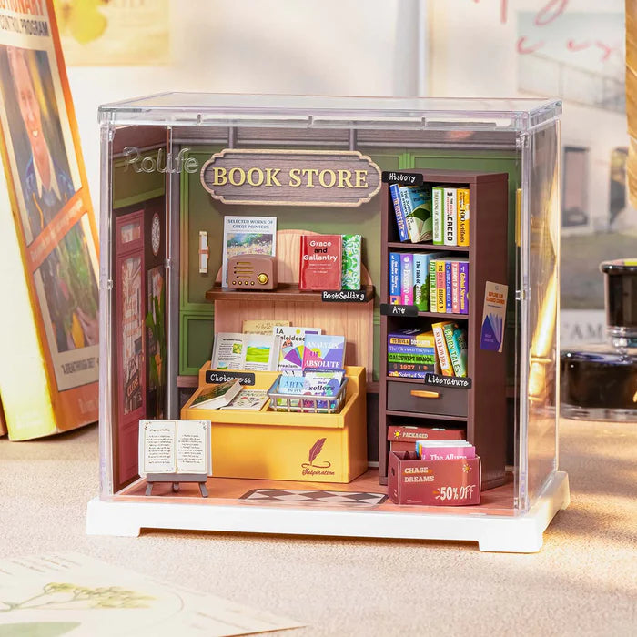 Miniature model of a book store with books and shelves inside a transparent box.