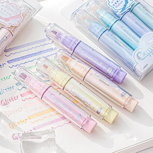Set of colorful markers with visible brand name on a notebook page.