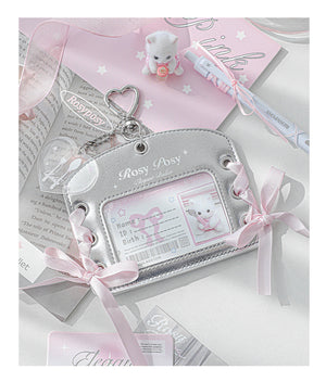 Silver baby card holder with pink ribbons and a teddy bear design on a white background