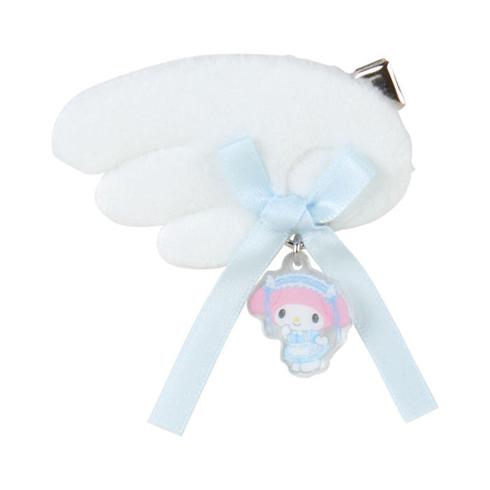 White cloud-shaped object with a blue ribbon and a small character charm on a white background
