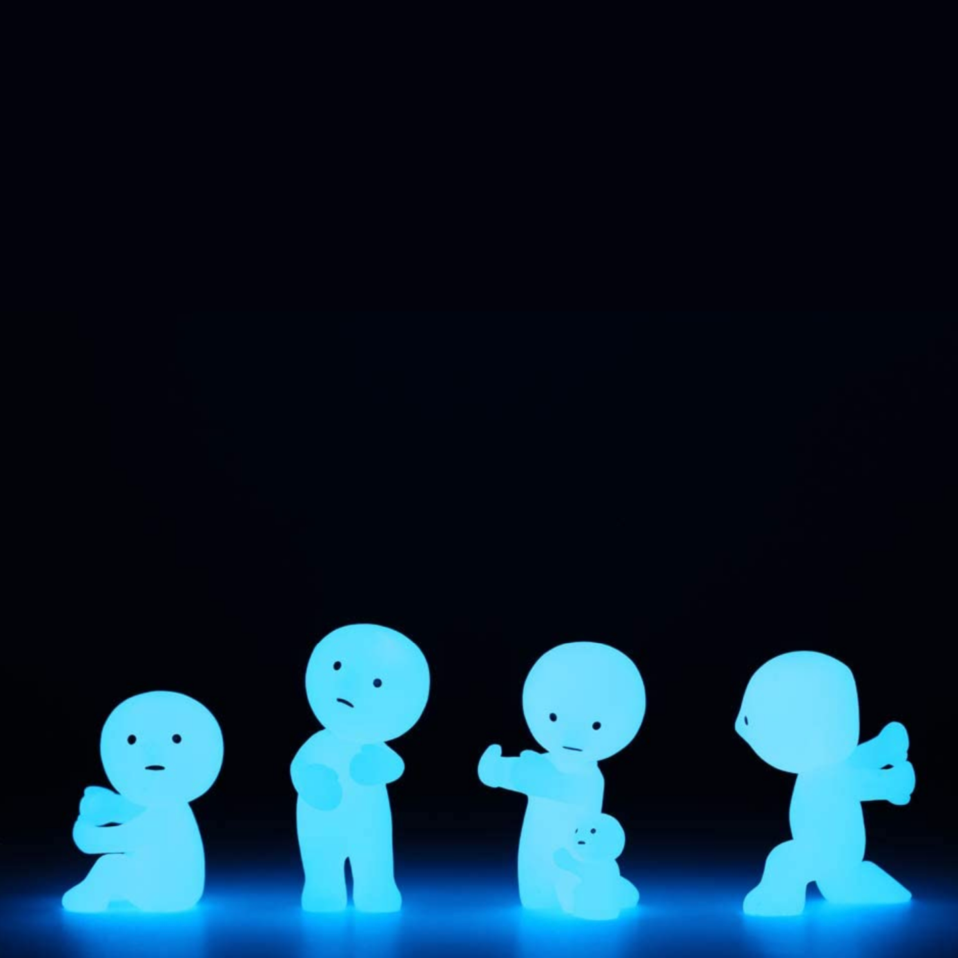 Four glowing blue figures on a black background