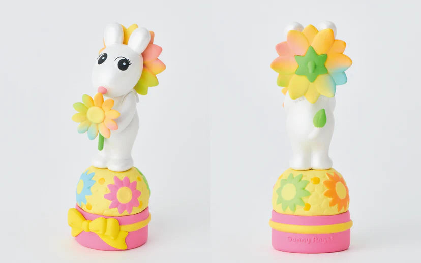 Two colorful unicorn toys with flower designs on a white background