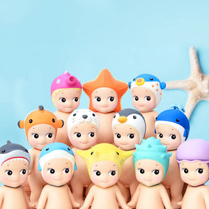 Set of cartoon baby dolls with colorful hats on a blue background