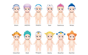 Set of 12 small figurines with colorful hats labeled from 'Shark' to 'Starfish'.
