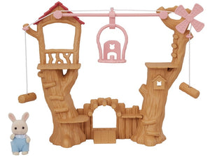 Toy treehouse with pink accents and a small rabbit figure on a white background