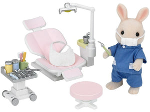 Toy dental office set with a rabbit-like character in a blue outfit.