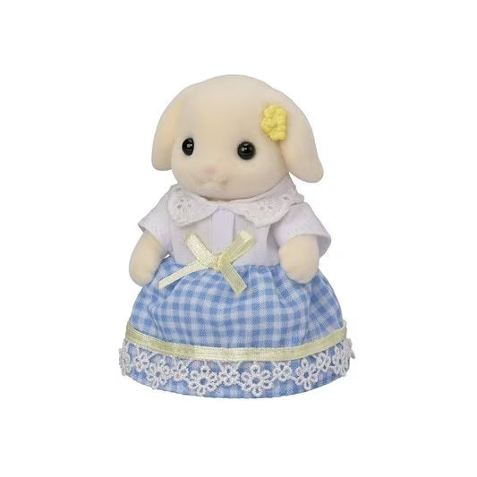 Stuffed toy lamb with a blue checkered dress on a white background