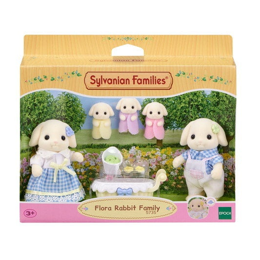 Sylvanian Families Flora Rabbit Family packaging with four rabbits and a table in a garden setting.