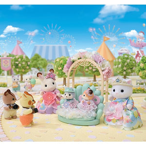 Toy figurines in a garden setting with a floral arch and clear blue sky.