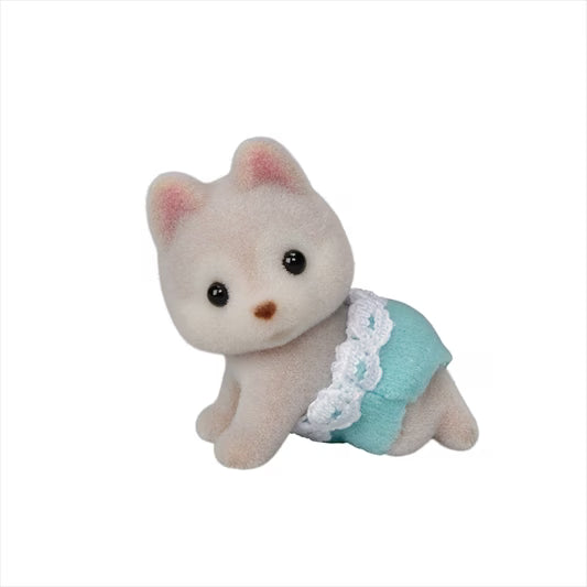Small plush cat toy with a blue dress on a white background
