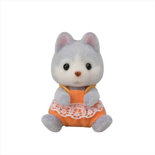 Plush toy cat in an orange outfit with a white lace trim on a white background