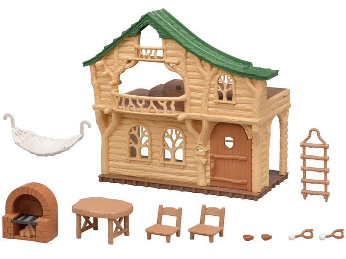Toy log cabin set with furniture and accessories on a white background