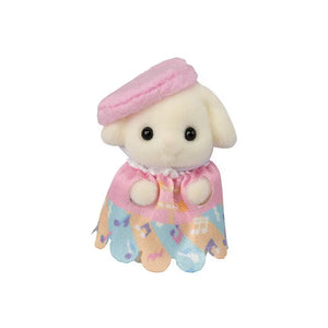 Small plush toy sheep with a pink hat and colorful scarf on a white background