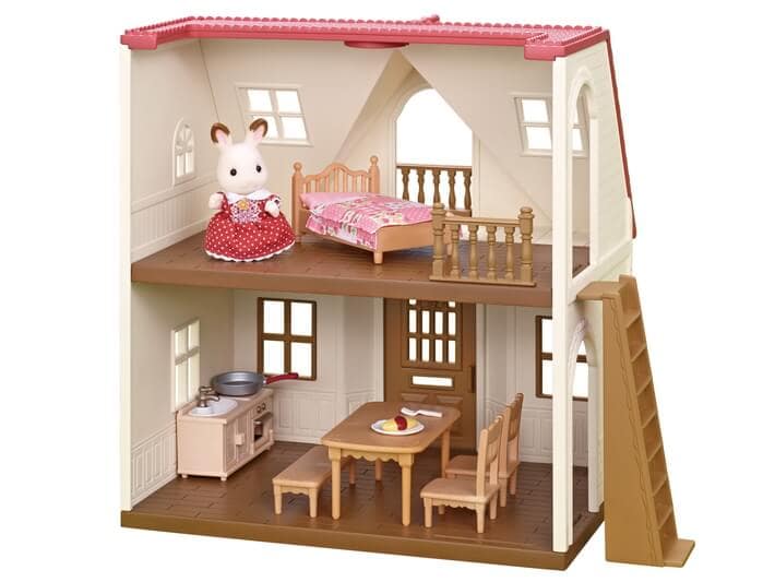 Toy dollhouse with furniture and a mouse figure on a white background